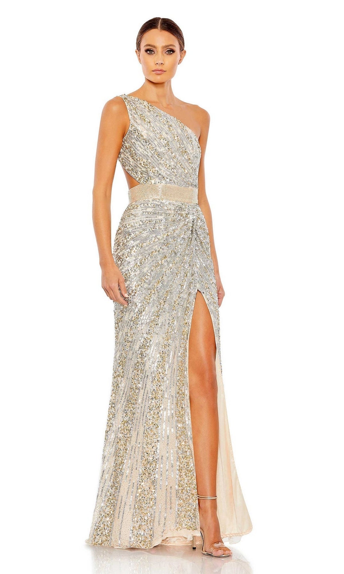 A woman models the Mac Duggal 5687 One-Shoulder Sequin Formal Dress—silver and gold with a thigh-high slit—paired with high-heeled sandals against a white background.